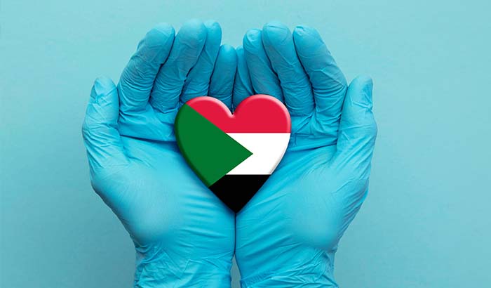 doctors-hands-wearing-surgical-gloves-holding-sudan-flag-heart2